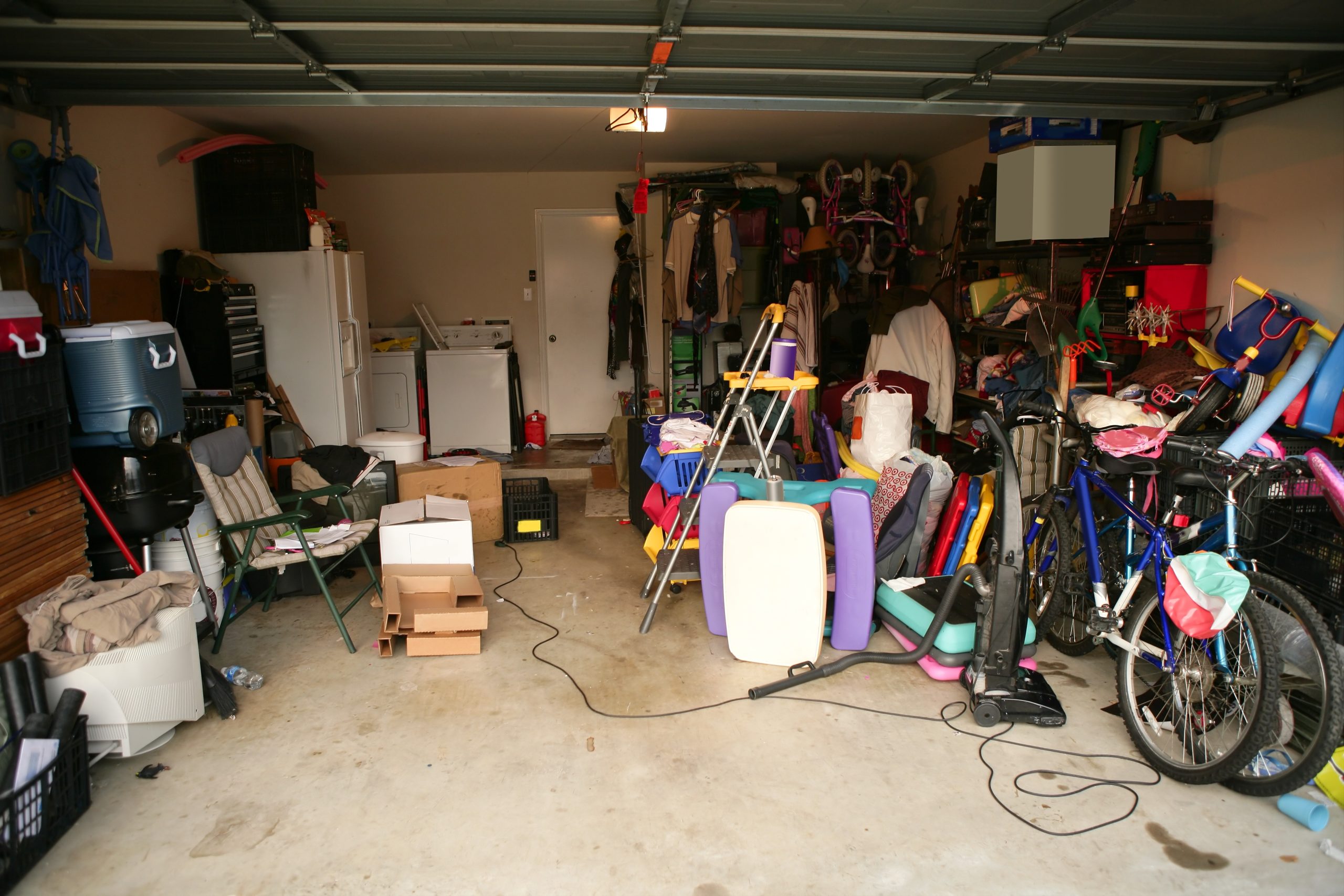 Messy garage, boxes on floor, overpacked and very unorganized